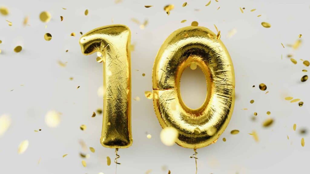 Gold number 10 balloon with confetti, celebrating a 10-year-old girl's birthday party