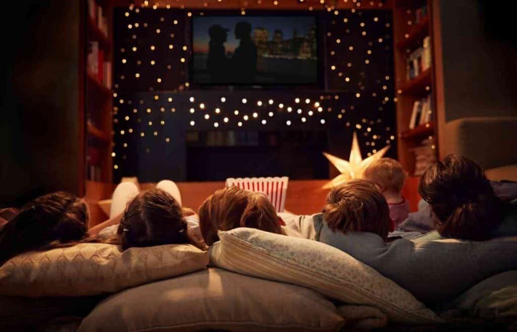 hildren watching a movie together at a cozy indoor movie night birthday party