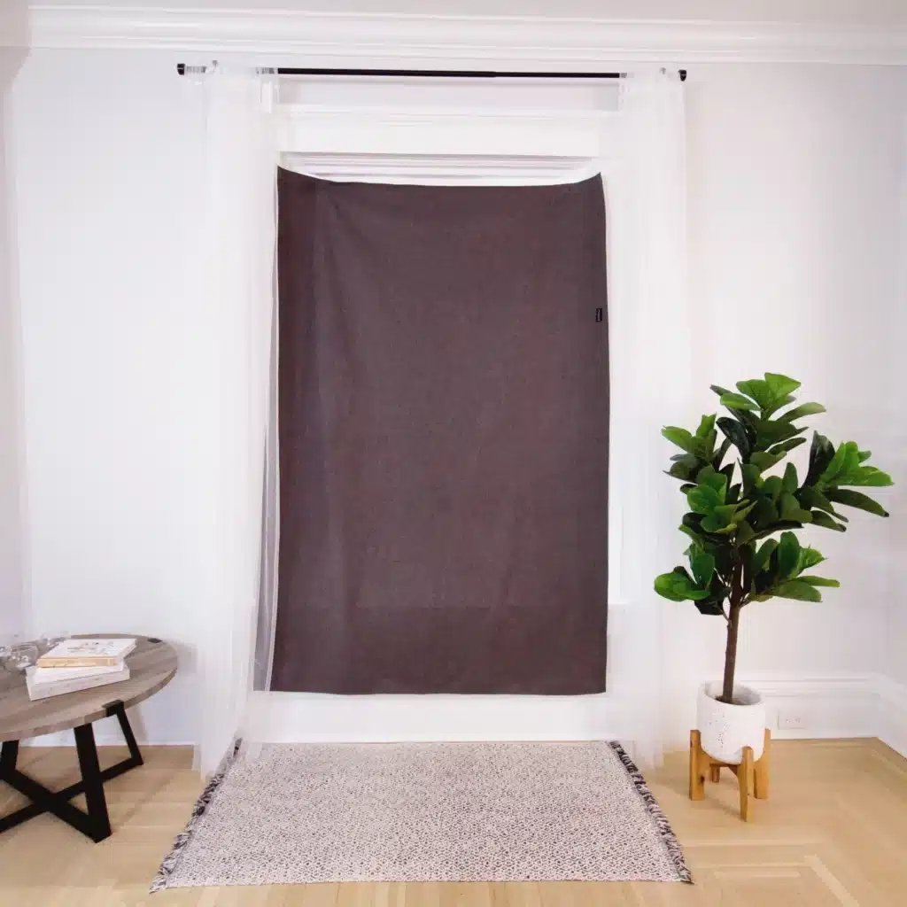 The Sleepout Curtain attached to a window. This is a portable curtain that is good for traveling with a baby or child.