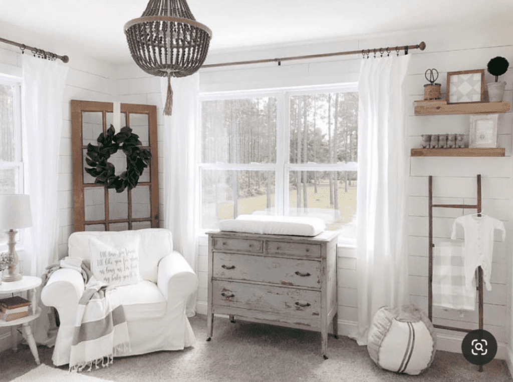 Farmhouse Theme Baby Boy Nursery with wreath and view to outside woods.