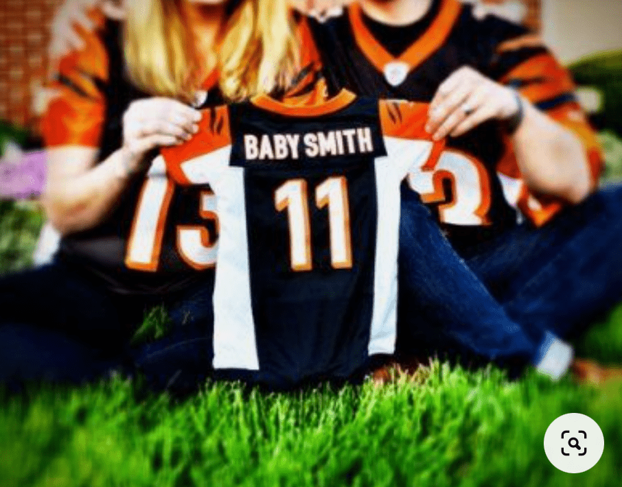 Baby announcement using a small sports jersey.