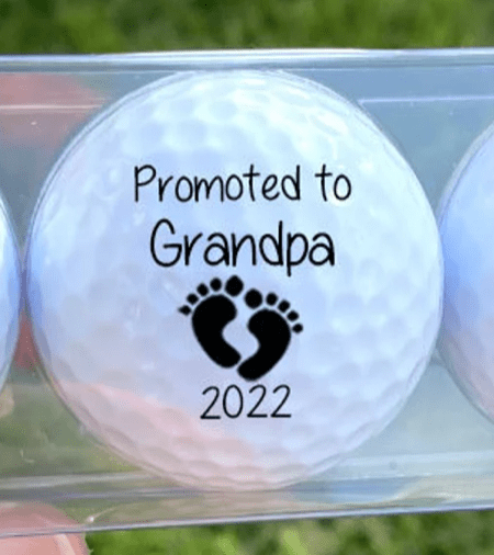 Golf ball that says promoted to grandpa for pregnancy announcement