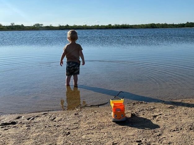 child on Ottawa Lake swimming beach Wisconsin