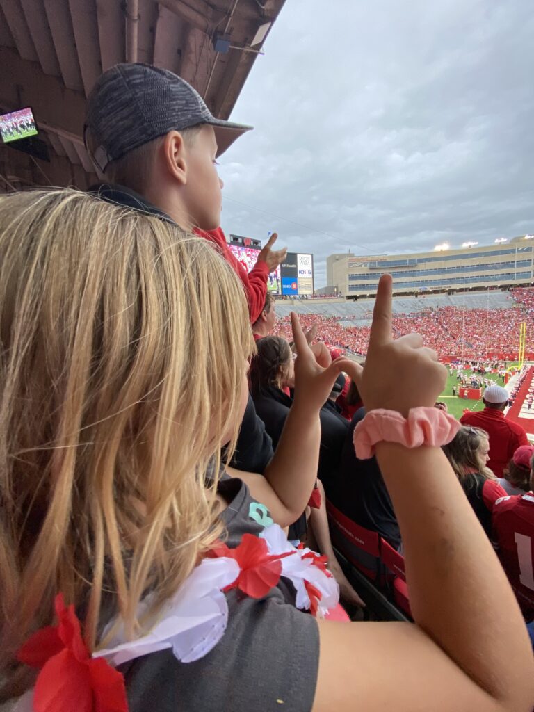 Kids cheer on the Wisconsin Badgers at a football game at Camp Randall.