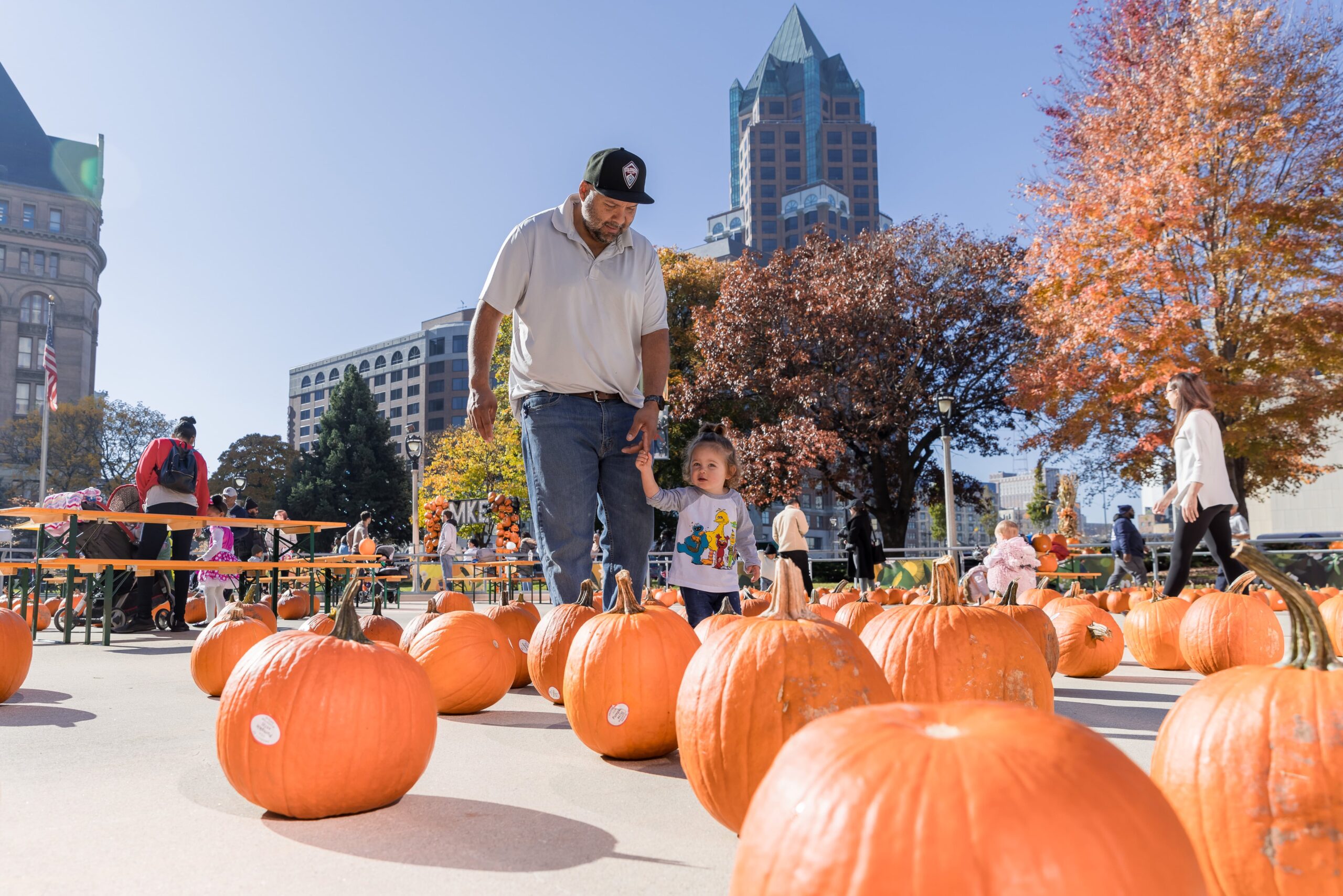 father and daughter in pumpkin patch at Jack-O-Lantern Jubilee in Red Arrow Park, downtown Milwaukee Wisconsin