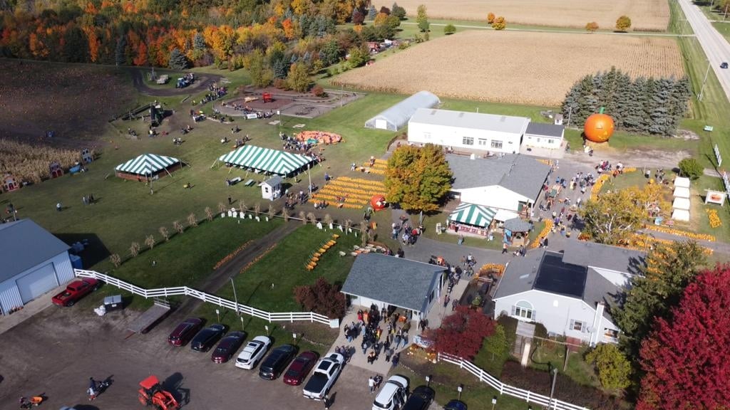 Aerial view of Swans' Pumpkin Farm with giant inflatable pumpkins and tents.