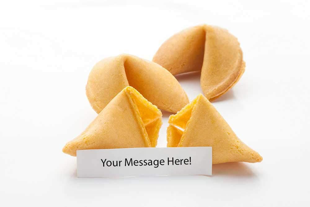 A group of golden-brown fortune cookies is arranged on a clean, white surface. The slip states "Your message here," inviting customization.