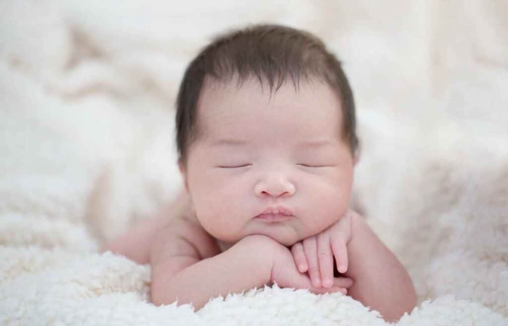 Peaceful newborn baby sleeping on a soft blanket, symbolizing the joy of parenthood and the miracle of new life