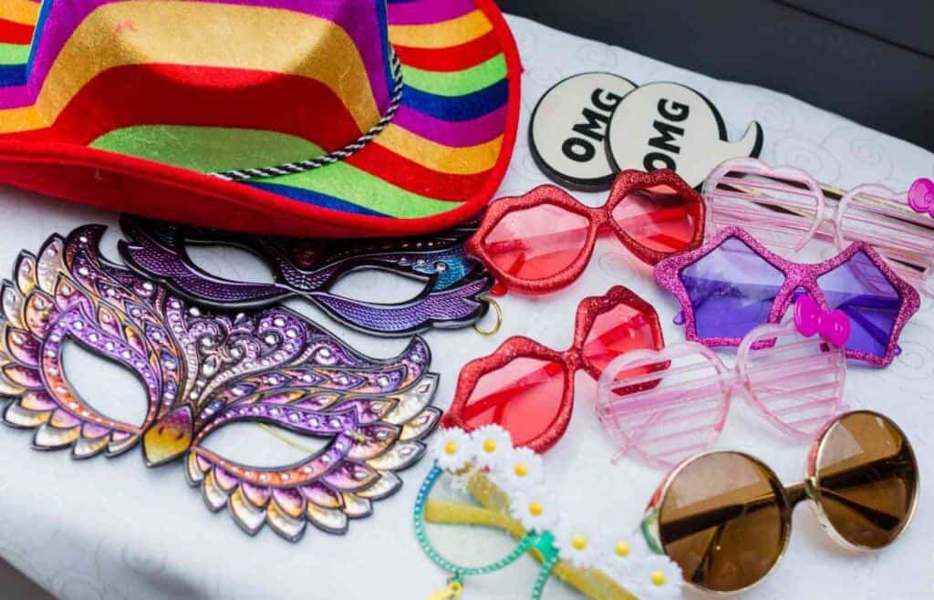 Colorful masks, sunglasses, and props for a fun photo booth at a kids' birthday party