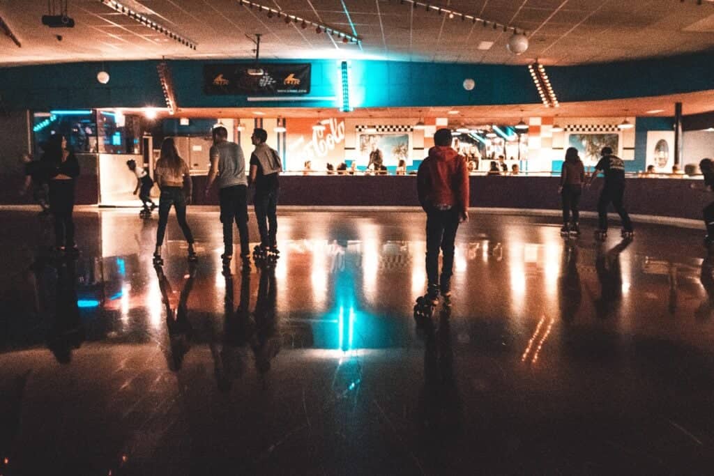 People roller skating at an indoor rink for a nostalgic roller skating birthday party