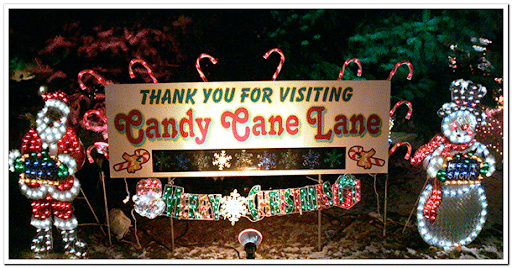 Candy Cane Lane thank you sign surrounded by colorful holiday lights and snowmen decorations in West Allis, Milwaukee.